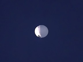 ADDS PENTAGON RESPONSE THAT IT WOULD NOT CONFIRM - A high altitude balloon floats over Billings, Mont., on Wednesday, Feb. 1, 2023. The U.S. is tracking a suspected Chinese surveillance balloon that has been spotted over U.S. airspace for a couple days, but the Pentagon decided not to shoot it down due to risks of harm for people on the ground, officials said Thursday, Feb. 2, 2023. The Pentagon would not confirm that the balloon in the photo was the surveillance balloon.