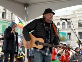 Rock legend Neil Young performs during a rally against the destruction of old growth forests on the front lawn of the legislature in Victoria, B.C., on Saturday, Feb. 25, 2023.