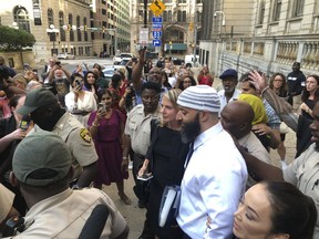 FILE -- Adnan Syed, center, leaves the Cummings Courthouse on Sept. 19, 2022, in Baltimore. The protracted legal odyssey of Syed, whose murder case rose to prominence through the hit podcast "Serial," marked its latest development Thursday, Feb. 2, 2023, when a Maryland appeals court heard arguments about whether the victim's family experienced improper treatment when a Baltimore court overturned Syed's conviction last year, allowing his release after more than two decades behind bars.