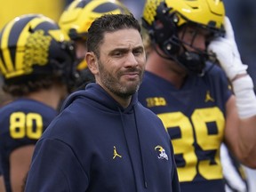 FILE - Michigan co-offensive coordinator and quarterbacks coach Matt Weiss waits for the team's NCAA college football game against Maryland in Ann Arbor, Mich., Sept. 24, 2022. The university has placed Weiss on leave, athletic department spokesman Kurt Svoboda confirmed Tuesday night, Jan. 17.