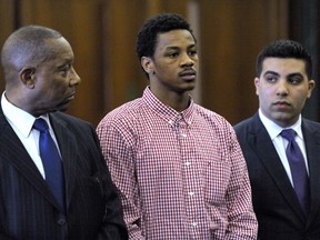 FILE - Former Michigan State basketball player Keith Appling, center, is is flanked by his attorneys, Cyril Hall, left, and Amir Makled as he is arraigned in Dearborn, Mich., on May 4, 2016. Wayne County Prosecutor Kym Worthy says 31-year-old Keith Damon Appling pleaded guilty Monday, Feb. 13, 2023, to one count each of second-degree murder and felony firearm in the killing of 66-year-old Clyde Edmonds.