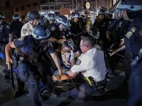 FILE - A protester is arrested on New York's Fifth Avenue by NYPD officers during a march on June 4, 2020, following the death of George Floyd. According to a report released Monday, Feb. 6, 2023, by a civilian review board, nearly 150 New York City police officers committed misconduct, including using excessive force, while responding to the 2020 protests over Floyd's killing.