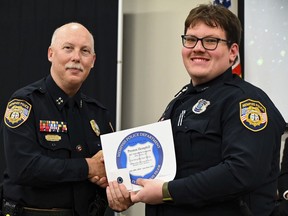 FILE - In this photo obtained from the Memphis, Tenn., Police Department's Facebook page, Preston Hemphill, right, receives a certificate from Memphis Assistant Chief of Police Don Crowe, left, after completing the training to join the department's Crisis Intervention Team on July 21, 2022. Records released Monday, Feb. 13, 2023, showed that Hemphill, the Memphis police officer who hit Tyre Nichols with a stun gun during a traffic stop that preceded Nichols' brutal beating by other officers, had a prior record of minor infractions. (Memphis Police Department via AP, File)