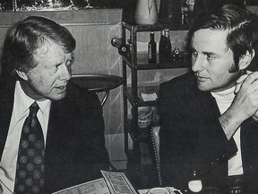 FILE - Associated Press Special Correspondent Walter R. Mears, right, talks with presidential candidate Jimmy Carter in Concord, N.H., before the New Hampshire primary election in 1976. As the former U.S. president starts hospice care in February 2023 at his home in Plains, Ga., many people are considering his impact. One man who knew him well was Mears, an AP special correspondent whose coverage of the 1976 presidential campaign won a Pulitzer Prize. Before Mears died in 2022, he wrote about Carter's life as an international envoy of peacemaking and democracy. (AP Photo/File)