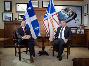 Newfoundland and Labrador Premier Andrew Furey and Quebec Premier François Legault pose in the office of the premier at the Confederation Building, in St. John's, on Friday, Feb. 24, 2023.