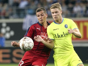 Bordeaux's Nicolas De Preville, left, and Gent's Sigurd Rosted battle for the ball during the Europa League playoff, first leg, soccer match between Gent and Bordeaux at the KAA Gent Stadium in Ghent, Belgium, Thursday, Aug. 23, 2018.