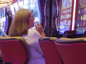 Gamblers play slot machines in a smoking section of the Hard Rock casino in Atlantic City, N.J., on Aug. 8, 2022. State lawmakers will hold a hearing on Feb. 13, 2023 to discuss a proposed law that would ban smoking in the casinos.