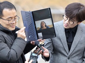 Vietnamese woman Nguyen Thi Thanh is seen on a computer monitor as she speaks outside the court at the Seoul Central District Court in Seoul, South Korea, Tuesday, Feb. 7, 2023. A South Korean court on Tuesday, Feb. 2023, ordered the government to pay 30 million won ($24,000) to a Vietnamese woman who survived a gunshot wound but lost several relatives when South Korean marines rampaged through her village during the Vietnam War in 1968.