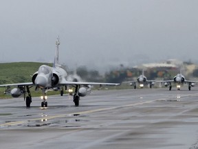 Taiwanese Mirage 2000 fighter jets taxi along a runway during a drill at an airbase in Hsinchu, Taiwan, Wednesday, Jan. 11.