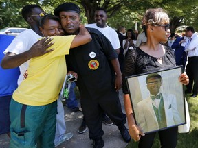 FILE - Mary Stewart, right, holds a photo of her son, Darrius Stewart, before a press conference outside The Commercial Appeal in Memphis, Tenn., July 13, 2016. The family of Darrius Stewart, a 19-year-old Black man who was fatally shot in a confrontation with a white Memphis police officer in 2015, has asked the city's top prosecutor to reopen the case, a lawyer said Wednesday, Feb. 15, 2023.