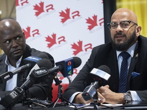 Joel DeBellefeuille, executive director of the Red Coalition, left, looks on as Alain Babineau, director of racial profiling for the Coalition speaks during a news conference in Montreal, Saturday, January 7, 2023. A private high school west of Montreal says it will act amid allegations administrators ignored complaints about racist bullying targeting two Black students for years.THE CANADIAN PRESS/Graham Hughes