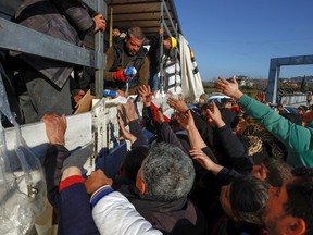 Volunteers distribute aid to affected people, in the aftermath of an earthquake, in Hatay, Turkey, Feb. 8.