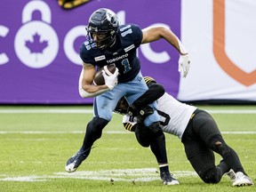 The Saskatchewan Roughriders signed receivers Juwan Brescacin and Jake Wienke on Tuesday. Hamilton Tiger-Cats defensive back Ciante Evans (0) tackles Toronto Argonauts wide receiver Juwan Brescacin (11) during second half CFL Eastern Conference final action in Toronto, on Sunday, December 5, 2021.