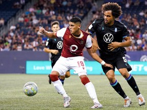 Forward Jared Ulloa (centre) is shown in action for Valour FC against Pacific FC on August 16, 2021, at IG Field in Winnipeg.