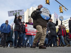 Attendees march and hold signs during the "March for Life" event on Wednesday, Feb. 1, 2023, in Richmond, Va.