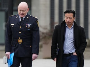 Vancouver Police Chief Adam Palmer, left, and Mayor Ken Sim, arrive for a news conference, in Vancouver, on Sunday, February 5, 2023. Vancouver city council is set to review recommendations for a $2.8 million grant to Vancouver Coastal Health.
