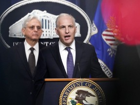 FILE - Justice Department's Assistant Attorney General for the National Security Division Matthew Olsenspeaks during a news conference at the Department of Justice in Washington, Jan. 27, 2023, as Attorney General Merrick Garlandlistens at left. The Biden administration officials urged Congress on Tuesday to renew a surveillance program that the U.S. government has long seen as vital in countering overseas terrorism, cyberattacks and espionage operations. The program, which is under the Foreign Intelligence Surveillance Act, or FISA, is set to expire at year's end unless Congress agrees to renew it.