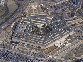 FILE - The Pentagon is seen from Air Force One as it flies over Washington, March 2, 2022. Defense officials tell Congress that the military services are still reviewing possible discipline of troops who refused the order to get the COVID-19 vaccine.