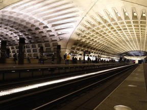 FILE - People waiting for the subway train at a Metro station, Jan. 6, 2022, in Washington. An armed man shot three people, killing one, in a Wednesday morning rampage in the nation's capital that started on a city bus and ended in a Metro tunnel after passengers attacked and disarmed him.
