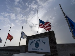 FILE - In this photo reviewed by U.S. military officials, flags fly at half-staff at Camp Justice, Aug. 29, 2021, in Guantanamo Bay Naval Base, Cuba. Majid Khan, the onetime courier for al-Qaida is a free man after serving more than 16 years at Guantanamo, and surviving torture at notorious CIA "black sites." The Pentagon announced the release of Pakistan citizen Khan on Thursday, Feb. 2, 2023. Khan is now in Belize, after that nation reached agreement with the Biden administration to take him.