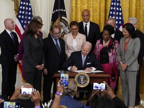 FILE - President Joe Biden signs an executive order in the East Room of the White House, May 25, 2022, in Washington. The order comes on the second anniversary of George Floyd's death, and is focused on policing. Biden is facing fresh pressure to make progress on police legislation after the killing of Tyre Nichols in Memphis