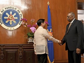 U.S. Secretary of Defense Lloyd James Austin III, right, shake hands with Philippine President Ferdinand Marcos Jr. during a courtesy call at the Malacanang Palace in Manila, Philippines on Thursday, Feb. 2, 2023.