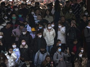 People, some wearing face masks visit the Temple of Heaven park in Beijing, Sunday, Feb. 26, 2023. Visitors flock to the tourist sites in cities in China after authorities lifted all bans on public gatherings from the outbreak of COVID-19.