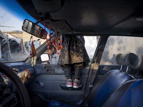 A young Bedouin girl looks to of a car window at the West Bank hamlet of Khan al-Ahmar, Sunday, Jan. 22, 2023. The long-running dispute over the West Bank Bedouin community of Khan al-Ahmar, which lost its last legal protection against demolition four years ago, resurfaced this week as a focus of the frozen Israeli-Palestinian conflict. Israel's new far-right ministers vow to evacuate the village as part of a wider project to expand Israeli presence in the 60% of the West Bank over which the military has full control. Palestinians seek that land for a future state.