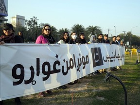 Members of a civil society group take part in a rally during a prayer ceremony for victims of Monday's suicide bombing in Peshawar, in Lahore, Pakistan, Saturday, Feb. 4, 2023.