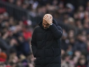 Manchester City's head coach Pep Guardiola reacts during the English Premier League soccer match between Manchester United and Manchester City at Old Trafford in Manchester, England, Saturday, Jan. 14, 2023.