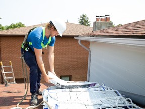 Michael, on the job site prepping shingles for a roofing job. Holmes Family Rescue.