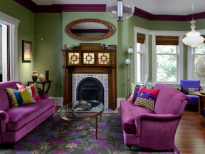 In the living room, cerise and purple upholstery is paired with a tiger-oak-lined mantel, inset with handprinted animal tiles.