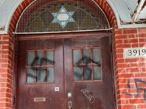 The defaced front of Montreal's Bagg St. Synagogue, seen on March 28, 2023.
