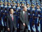 Visiting Canadian Prime Minister Jean Chretien (R) walks beside Chinese Premier Wen Jiabao, 22 October 2003, during a review of the honour guard at a welcoming ceremony at the Great Hall of the People in Beijing. Chretien and his delegation arrived late 21 October for an official four-day visit to China. AFP PHOTO/Frederic J. BROWN