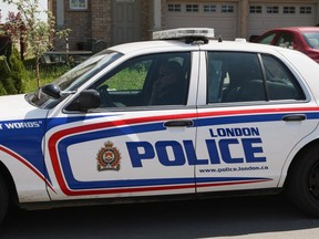 Police say the man, who shot and wounded two officers after stabbing an individual to death over the weekend in London Ont., didn't have a license to legally own the long gun which was recovered at the scene. A London Police cruiser sits outside a home in London, Ontario on Friday, May 30, 2014.