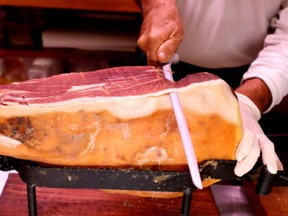 A grocer slices prosciutto ham in a deli in Rome, Italy, October 3, 2019.