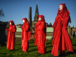An Extinction Rebellion activist is seen crying during a Funeral for COP26 at the Necropolis on November 13, 2021 in Glasgow, United Kingdom. (Photo by Peter Summers/Getty Images)