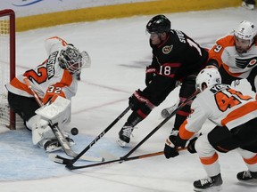 Philadelphia Flyers goaltender Felix Sandstrom makes a save on Ottawa Senators left wing Tim Stutzle as defenceman Cam York and defenceman Ivan Provorov defend during first period NHL action, Thursday, March 30, 2023 in Ottawa.