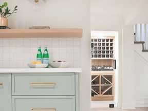 A stylish mint-green wet bar and custom pantry, both with millwork by Gravelle Woodworking, were incorporated into the basement design.