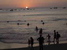 People bath in the Pacific Ocean at Agua Dulce beach at sunset in Lima, Peru, Wednesday, Feb. 8, 2023.&ampnbsp;Environmental groups are praising a newly signed treaty that will help protect biodiversity in the high seas, where conservation across the vast stretches across the planet have been hampered by a confusing patchwork of laws.