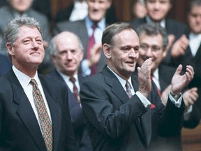 Bill Clinton receives a standing ovation from Jean Chretien and MPs after his speech in the House of Commons. AFP PHOTO