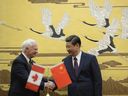 Former Governor General David Johnston (L) shakes hands with Chinese President Xi Jinping (R) after a signing ceremony at the Great Hall of the People in Beijing on October 18, 2013. Photo by KOTA ENDOKOTA ENDO/AFP/Getty Images