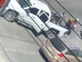 A woman is carried to the back of a white pickup truck in this still image obtained from social media video that allegedly shows the kidnapping of Americans in Matamoros, Mexico March 3, 2023.