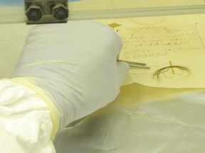 Scientists handle a lock of Beethoven's hair at the  Max Planck Institute for the Science of Human History.