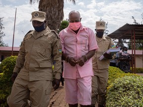 October 02, 2020 "Hotel Rwanda" hero Paul Rusesabagina in the pink inmate's uniform arriving at Nyarugenge Court of Justice in Kigali, Rwanda, surrounded by guards of Rwanda Correctional Service (RCS)