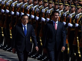 Prime Minister Justin Trudeau and Chinese Premier Li Keqiang inspect a Chinese honour guard during a welcome ceremony at the Great Hall of the People in Beijing on August 31, 2016.