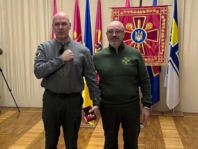 Dan Bilak, left, is awarded a medal “for support to the armed forces of Ukraine,” by Ukrainian Defence Minister Oleksii Reznikov.