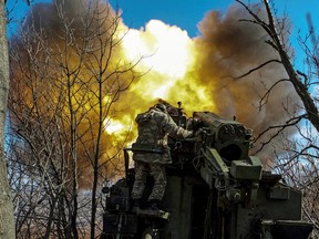 Ukrainian soldiers fire a 2S5 Giatsint-S self-propelled howitzer towards Russian troops outside the frontline town of Bakhmut, Ukraine March 5, 2023. Kyiv had appeared ready to withdraw from Bakhmut, but now says it is committed to holding on to break Russia’s assault force.