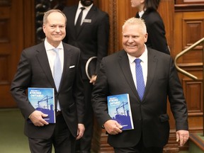 Ontario Finance Minister Peter Bethlenfalvy, left, and Premier Doug Ford arrive to table the provincial budget at the legislature at Queen's Park in Toronto on Thursday, March 23, 2023.