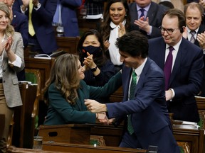 Prime Minister Justin Trudeau, centre right, embraces Finance Minister Chrystia Freeland, centre left, as she presents the federal budget in the House of Commons on March 28.